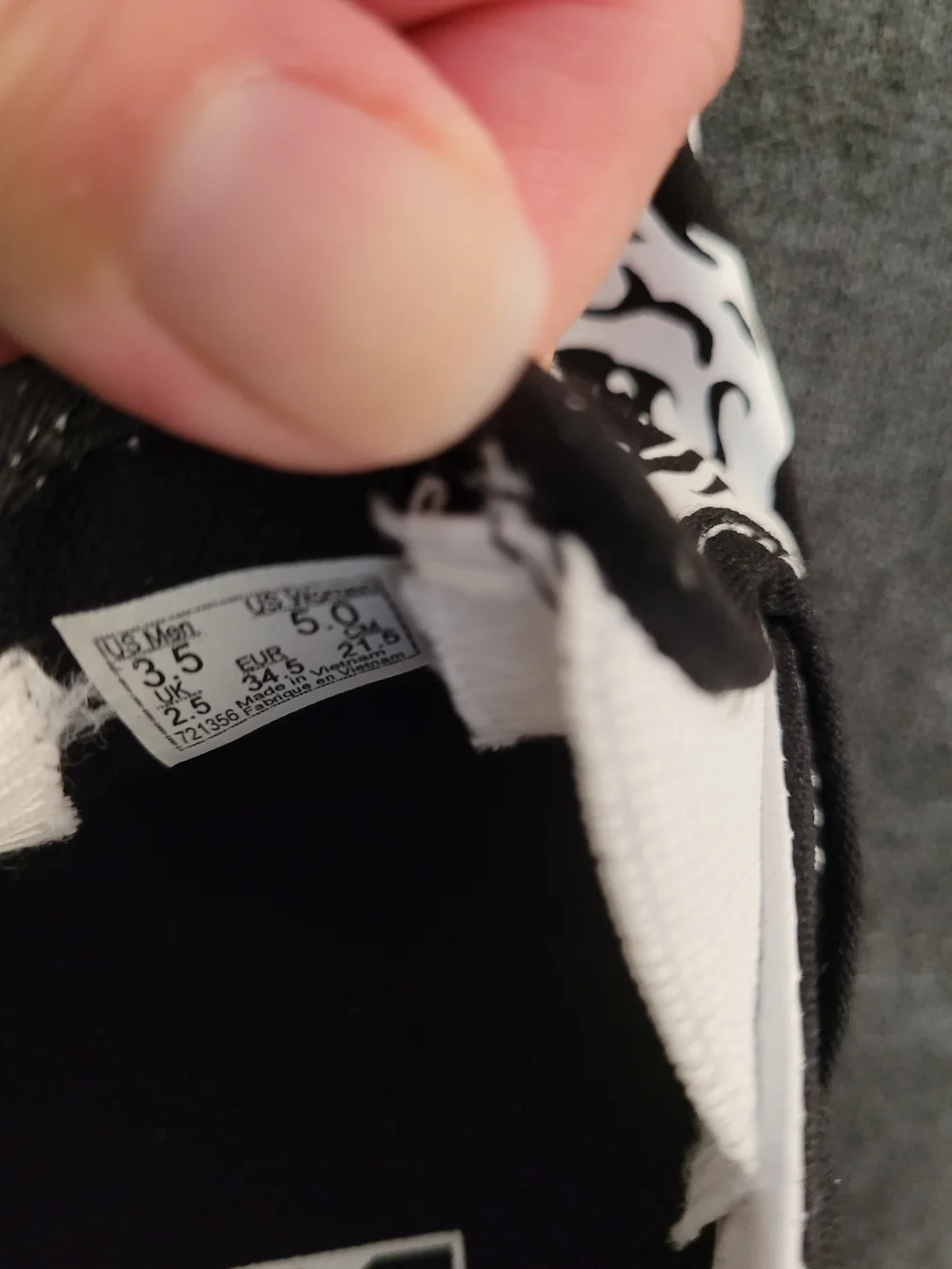 Vans Classic Kids Black & White Slip-On Sneakers with Skull Graphic